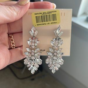 These clip on earrings have never been worn, and are about 3 inches long.